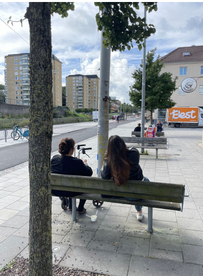 Two people sitting on a bench at Vågmästareplatsen during on-site observation
